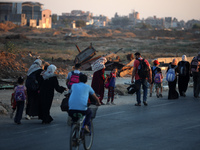 Displaced Palestinians are leaving al-Bureij refugee camp towards the west, after the Israeli army issued a new evacuation order, in the cen...