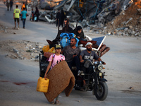 Displaced Palestinians are leaving al-Bureij refugee camp towards the west, after the Israeli army issued a new evacuation order, in the cen...