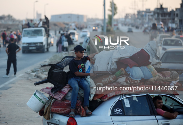 Displaced Palestinians are leaving al-Bureij refugee camp towards the west, after the Israeli army issued a new evacuation order, in the cen...