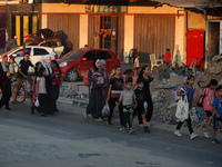 Displaced Palestinians are leaving al-Bureij refugee camp towards the west, after the Israeli army issued a new evacuation order, in the cen...