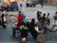 Displaced Palestinians are leaving al-Bureij refugee camp towards the west, after the Israeli army issued a new evacuation order, in the cen...