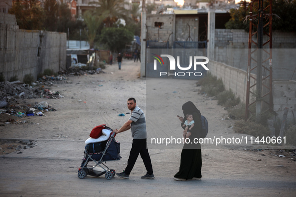 Displaced Palestinians are leaving al-Bureij refugee camp towards the west, after the Israeli army issued a new evacuation order, in the cen...