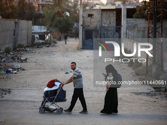 Displaced Palestinians are leaving al-Bureij refugee camp towards the west, after the Israeli army issued a new evacuation order, in the cen...