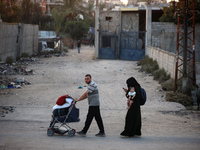 Displaced Palestinians are leaving al-Bureij refugee camp towards the west, after the Israeli army issued a new evacuation order, in the cen...