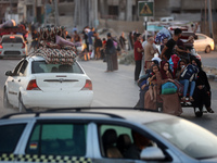 Displaced Palestinians are leaving al-Bureij refugee camp towards the west, after the Israeli army issued a new evacuation order, in the cen...