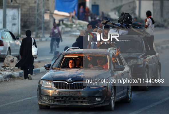 Displaced Palestinians are leaving al-Bureij refugee camp towards the west, after the Israeli army issued a new evacuation order, in the cen...