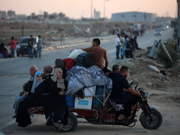 Displaced Palestinians are leaving al-Bureij refugee camp towards the west, after the Israeli army issued a new evacuation order, in the cen...