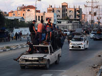 Displaced Palestinians are leaving al-Bureij refugee camp towards the west, after the Israeli army issued a new evacuation order, in the cen...