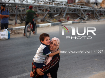 Displaced Palestinians are leaving al-Bureij refugee camp towards the west, after the Israeli army issued a new evacuation order, in the cen...