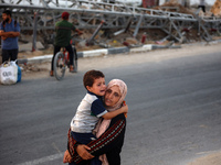 Displaced Palestinians are leaving al-Bureij refugee camp towards the west, after the Israeli army issued a new evacuation order, in the cen...