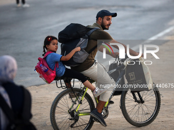 Displaced Palestinians are leaving al-Bureij refugee camp towards the west, after the Israeli army issued a new evacuation order, in the cen...