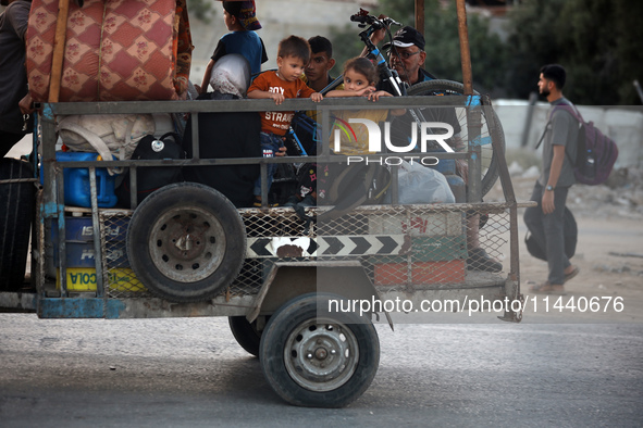 Displaced Palestinians are leaving al-Bureij refugee camp towards the west, after the Israeli army issued a new evacuation order, in the cen...