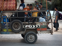 Displaced Palestinians are leaving al-Bureij refugee camp towards the west, after the Israeli army issued a new evacuation order, in the cen...