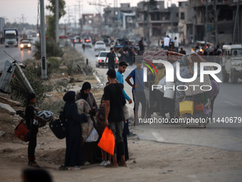 Displaced Palestinians are leaving al-Bureij refugee camp towards the west, after the Israeli army issued a new evacuation order, in the cen...