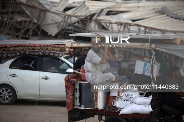 Displaced Palestinians are leaving al-Bureij refugee camp towards the west, after the Israeli army issued a new evacuation order, in the cen...