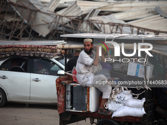 Displaced Palestinians are leaving al-Bureij refugee camp towards the west, after the Israeli army issued a new evacuation order, in the cen...