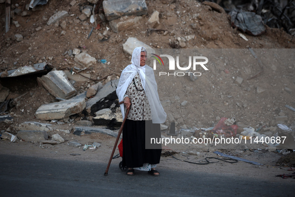 Displaced Palestinians are leaving al-Bureij refugee camp towards the west, after the Israeli army issued a new evacuation order, in the cen...