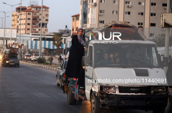 Displaced Palestinians are leaving al-Bureij refugee camp towards the west, after the Israeli army issued a new evacuation order, in the cen...