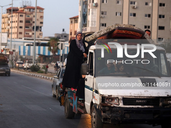 Displaced Palestinians are leaving al-Bureij refugee camp towards the west, after the Israeli army issued a new evacuation order, in the cen...