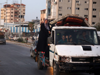 Displaced Palestinians are leaving al-Bureij refugee camp towards the west, after the Israeli army issued a new evacuation order, in the cen...