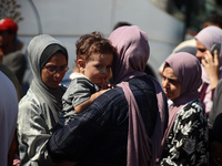 A group of Palestinian children and patients are awaiting in Deir Al-Balah, central Gaza Strip, on July 28, 2024, for their medical evacuati...