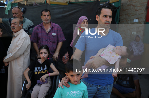 A group of Palestinian children and patients are awaiting in Deir Al-Balah, central Gaza Strip, on July 28, 2024, for their medical evacuati...