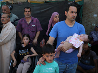 A group of Palestinian children and patients are awaiting in Deir Al-Balah, central Gaza Strip, on July 28, 2024, for their medical evacuati...