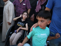 A group of Palestinian children and patients are awaiting in Deir Al-Balah, central Gaza Strip, on July 28, 2024, for their medical evacuati...