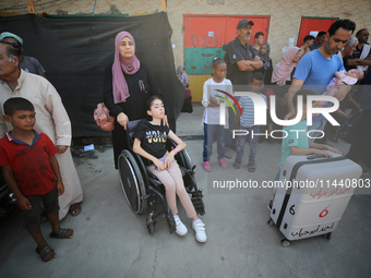 A group of Palestinian children and patients are awaiting in Deir Al-Balah, central Gaza Strip, on July 28, 2024, for their medical evacuati...