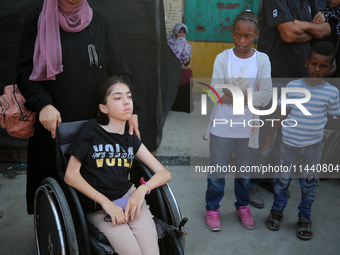 A group of Palestinian children and patients are awaiting in Deir Al-Balah, central Gaza Strip, on July 28, 2024, for their medical evacuati...