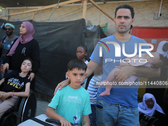 A group of Palestinian children and patients are awaiting in Deir Al-Balah, central Gaza Strip, on July 28, 2024, for their medical evacuati...