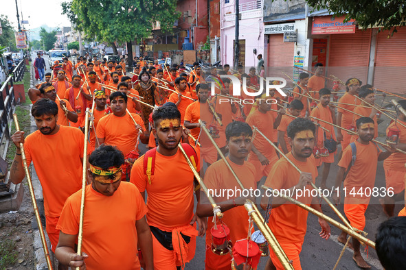 Kanwariyas are carrying holy water from the shrine 'Galta Peeth Tirtha' and going back to their pilgrimage in the auspicious month of 'Sharv...