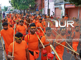 Kanwariyas are carrying holy water from the shrine 'Galta Peeth Tirtha' and going back to their pilgrimage in the auspicious month of 'Sharv...