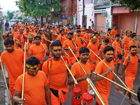 Kanwariyas are carrying holy water from the shrine 'Galta Peeth Tirtha' and going back to their pilgrimage in the auspicious month of 'Sharv...