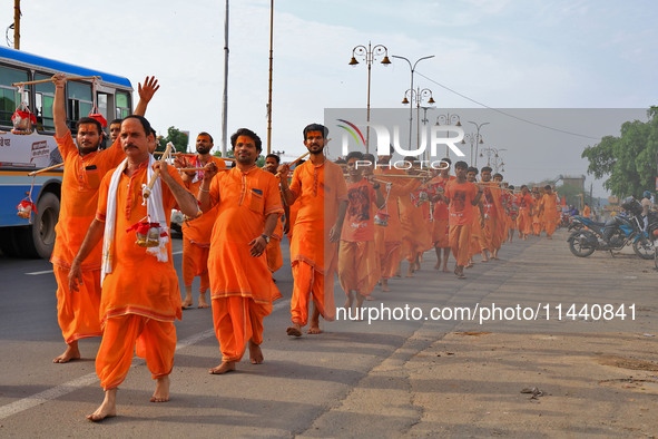 Kanwariyas are carrying holy water from the shrine 'Galta Peeth Tirtha' and going back to their pilgrimage in the auspicious month of 'Sharv...