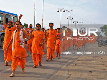 Kanwariyas are carrying holy water from the shrine 'Galta Peeth Tirtha' and going back to their pilgrimage in the auspicious month of 'Sharv...