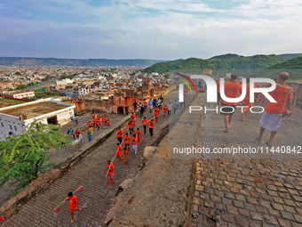 Kanwariyas are carrying holy water from the shrine 'Galta Peeth Tirtha' and going back to their pilgrimage in the auspicious month of 'Sharv...