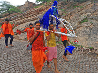 Kanwariyas are carrying holy water from the shrine 'Galta Peeth Tirtha' and going back to their pilgrimage in the auspicious month of 'Sharv...