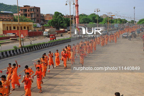 Kanwariyas are carrying holy water from the shrine 'Galta Peeth Tirtha' and going back to their pilgrimage in the auspicious month of 'Sharv...