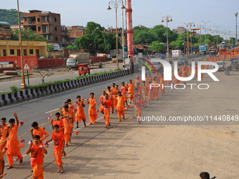 Kanwariyas are carrying holy water from the shrine 'Galta Peeth Tirtha' and going back to their pilgrimage in the auspicious month of 'Sharv...