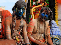 Jaipur: An artist is dressing up while kanwariyas are carrying holy water from the shrine 'Galta Peeth Tirtha' and going back to their pilgr...