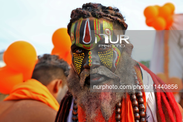 Jaipur: An artist is dressing up while kanwariyas are carrying holy water from the shrine 'Galta Peeth Tirtha' and going back to their pilgr...