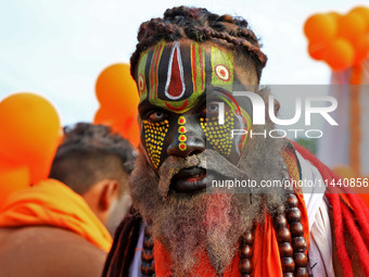 Jaipur: An artist is dressing up while kanwariyas are carrying holy water from the shrine 'Galta Peeth Tirtha' and going back to their pilgr...