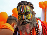 Jaipur: An artist is dressing up while kanwariyas are carrying holy water from the shrine 'Galta Peeth Tirtha' and going back to their pilgr...