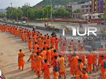 Kanwariyas are carrying holy water from the shrine 'Galta Peeth Tirtha' and going back to their pilgrimage in the auspicious month of 'Sharv...