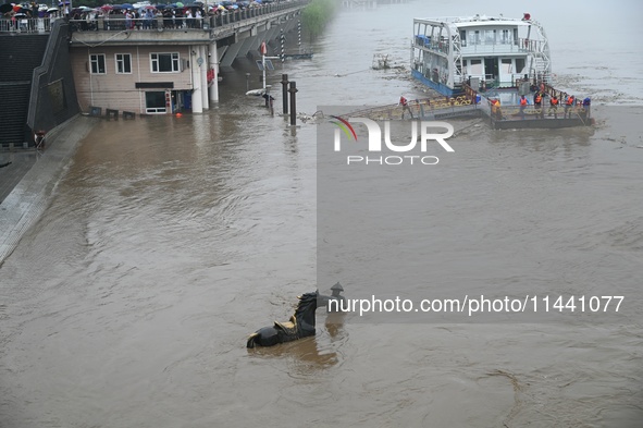 Bronze sculptures of horses and warriors are being seen submerged by floods at the Toudao wharf in Jilin City, Jilin province, China, on Jul...