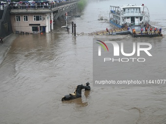 Bronze sculptures of horses and warriors are being seen submerged by floods at the Toudao wharf in Jilin City, Jilin province, China, on Jul...