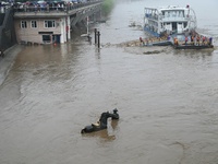 Bronze sculptures of horses and warriors are being seen submerged by floods at the Toudao wharf in Jilin City, Jilin province, China, on Jul...