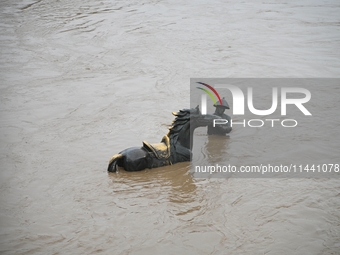 Bronze sculptures of horses and warriors are being seen submerged by floods at the Toudao wharf in Jilin City, Jilin province, China, on Jul...