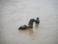 Bronze sculptures of horses and warriors are being seen submerged by floods at the Toudao wharf in Jilin City, Jilin province, China, on Jul...